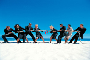 Business People Playing Tug-of-War on the Beach