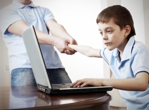 Father dragging son from the computer